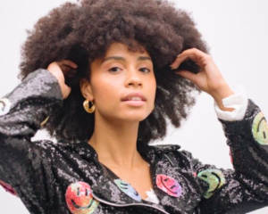 A young woman with afro hair wearing a sequin biker jacket for Scotland Re:Design Fashion Festival