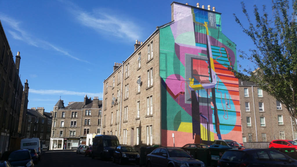 Image of a multicoloured mural by artists Fraser Gray & Martin McGuinness on a gable end wall in Stobswell, Dundee.